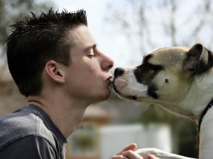 Boy Kissing His Dog - Bigstock