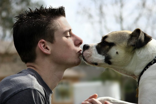 Boy Kissing His Dog - Bigstock